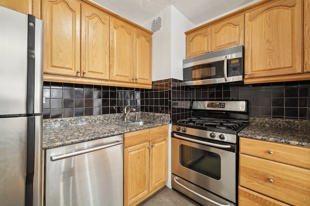 300 E 40th St Unit 6X, New York City, NY 10016 - kitchen with stainless steel appliances, dark stone countertops, and backsplash
