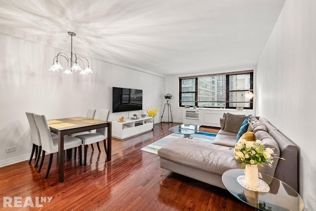 235 E 57th St Unit 14C, New York City, NY 10022 - living area featuring a chandelier, wood finished floors, and baseboards