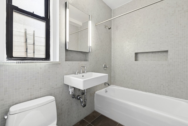 675 W End Ave Unit 11C, New York City, NY 10025 - bathroom featuring tile walls, toilet, a sink, shower / washtub combination, and tile patterned flooring