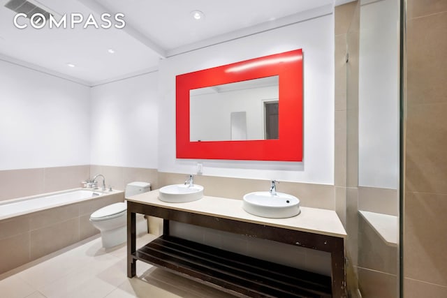 8 Thomas St Unit 2, New York City, NY 10007 - bathroom with vanity, tile patterned floors, a garden tub, and recessed lighting