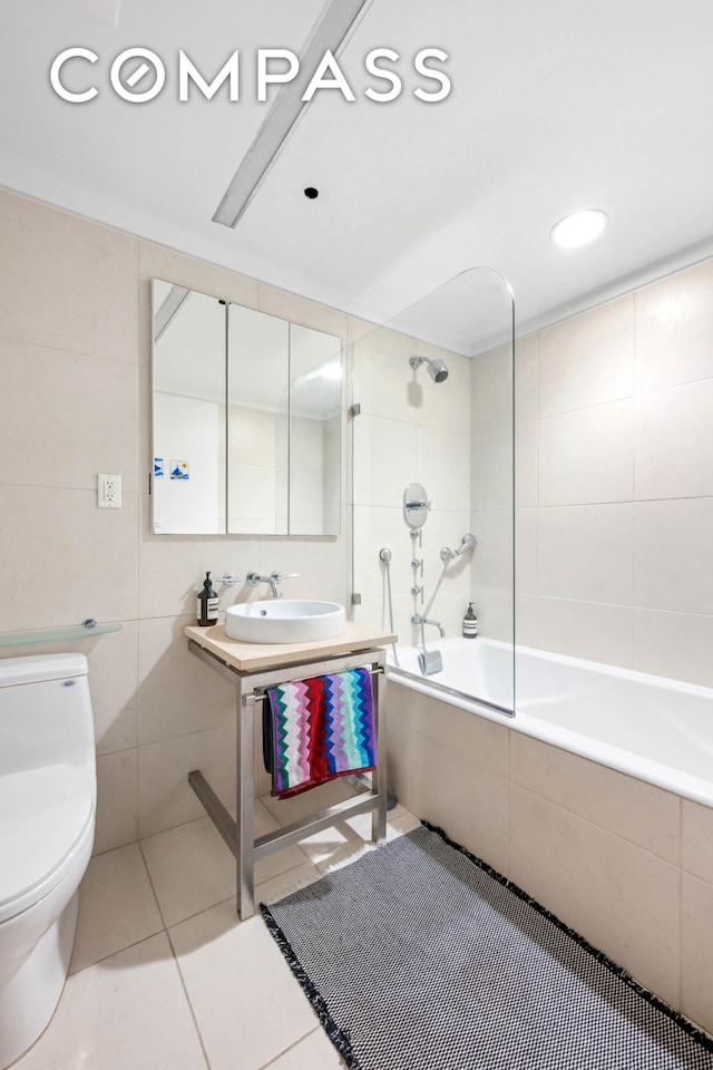 8 Thomas St Unit 2, New York City, NY 10007 - bathroom featuring a sink, tile walls, toilet, tiled shower / bath, and tile patterned flooring