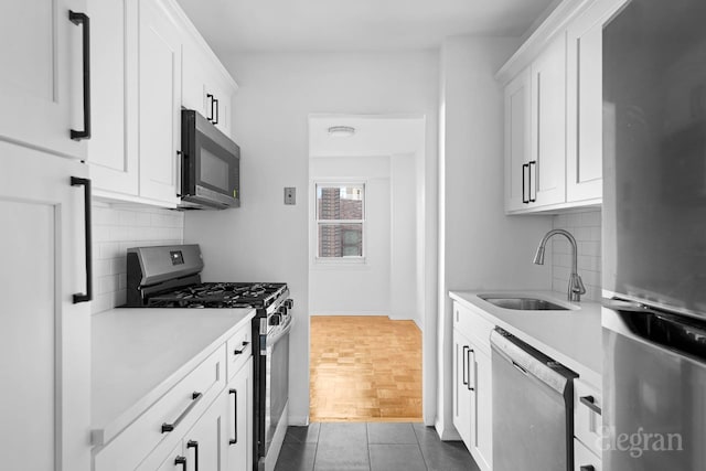 445 E 86th St Unit 6G, New York City, NY 10028 - kitchen featuring stainless steel appliances, a sink, decorative backsplash, and light countertops