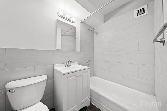 445 E 86th St Unit 6G, New York City, NY 10028 - full bathroom featuring vanity, bathing tub / shower combination, toilet, and tile walls