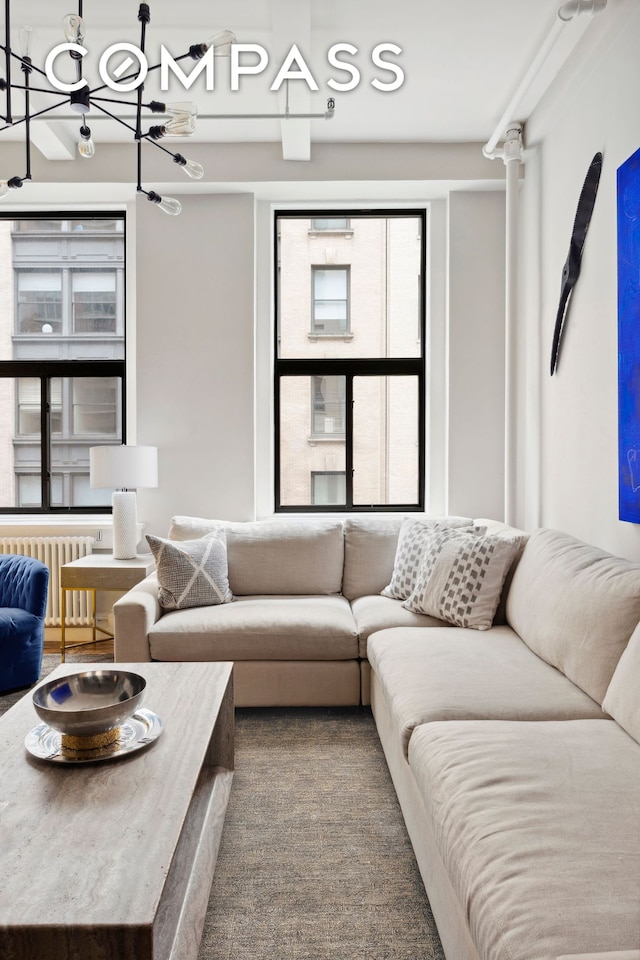 129 W 22nd St Unit 5A, New York City, NY 10011 - living room featuring radiator and a chandelier