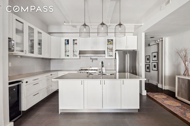 129 W 22nd St Unit 5A, New York City, NY 10011 - kitchen with freestanding refrigerator, beverage cooler, backsplash, and white cabinets