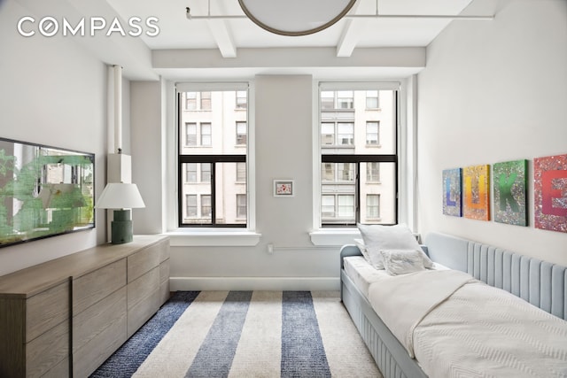129 W 22nd St Unit 5A, New York City, NY 10011 - bedroom featuring multiple windows, beamed ceiling, baseboards, carpet, and radiator heating unit