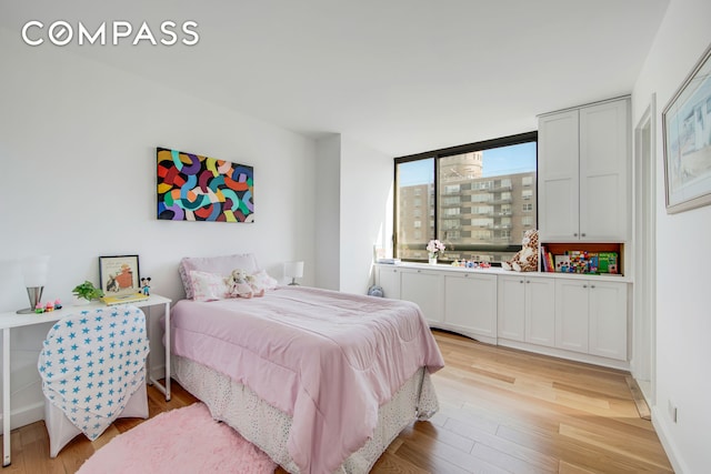 171 E 84th St Unit 31C, New York City, NY 10028 - bedroom featuring light wood-type flooring