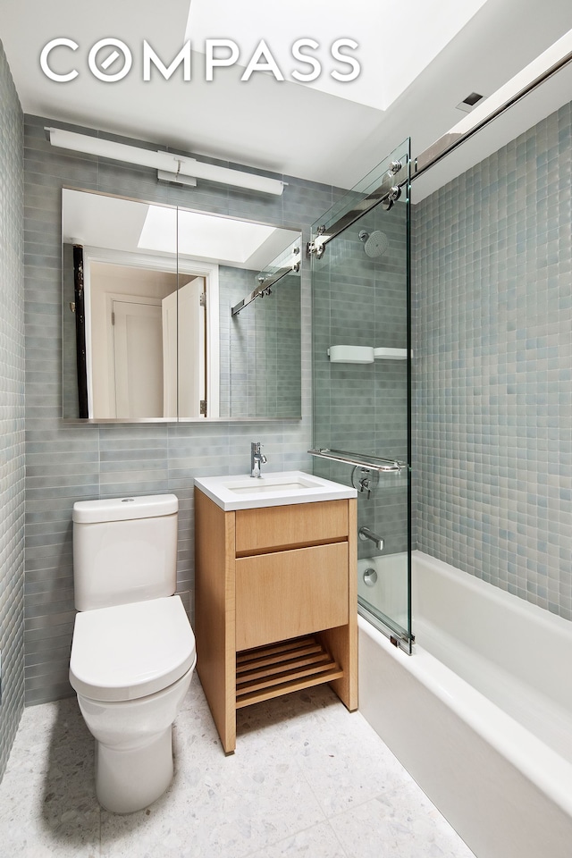 435 E 85th St Unit 4F, New York City, NY 10028 - full bath with bath / shower combo with glass door, vanity, and tile walls
