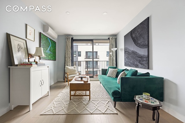 511 Evergreen Ave Unit 3D, New York City, NY 11221 - living room with an AC wall unit, light wood-style floors, and baseboards