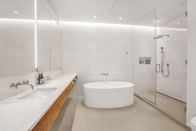 30 E 21st St Unit 3B, New York City, NY 10010 - full bathroom with a freestanding tub, vanity, a shower stall, tile patterned floors, and toilet