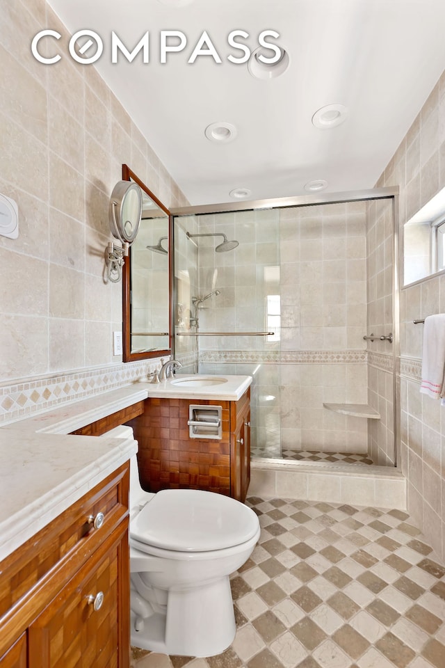 175 E 62nd St Unit 9D, New York City, NY 10065 - full bath featuring tile walls, vanity, a stall shower, and recessed lighting