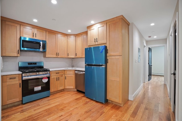 60-14 Menahan St, New York City, NY 11385 - kitchen with stainless steel appliances, light brown cabinets, light wood-style flooring, light countertops, and recessed lighting