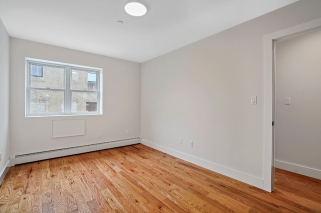 60-14 Menahan St, New York City, NY 11385 - spare room featuring a baseboard radiator and light wood-style flooring