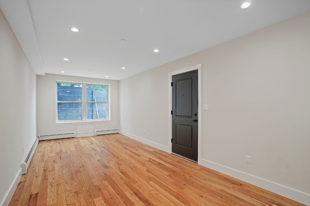 60-14 Menahan St, New York City, NY 11385 - spare room featuring light wood-type flooring, recessed lighting, and a baseboard radiator