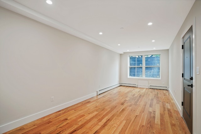 60-14 Menahan St, New York City, NY 11385 - empty room with light wood finished floors, recessed lighting, and baseboard heating