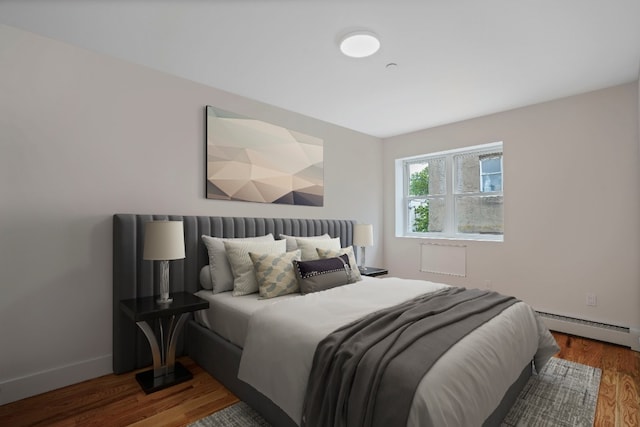 60-14 Menahan St, New York City, NY 11385 - bedroom featuring a baseboard heating unit and wood finished floors