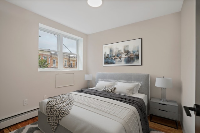60-14 Menahan St, New York City, NY 11385 - bedroom featuring a baseboard radiator and wood finished floors