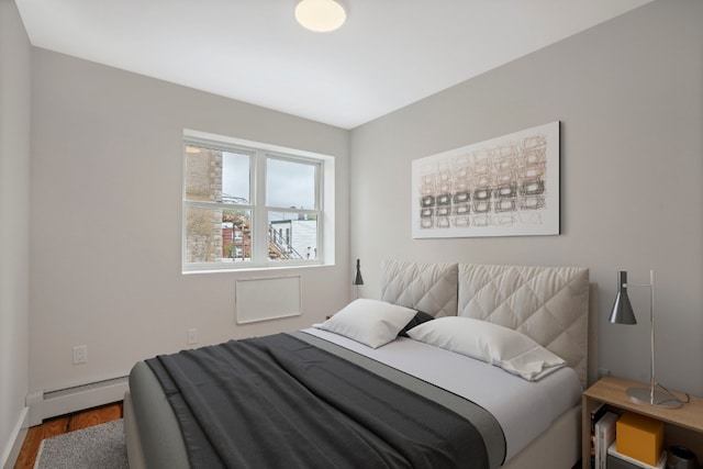 60-14 Menahan St, New York City, NY 11385 - bedroom with a baseboard radiator and wood finished floors