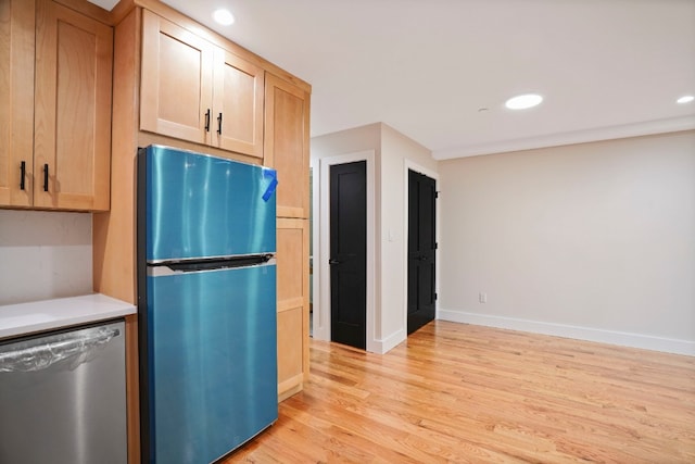 60-14 Menahan St, New York City, NY 11385 - kitchen with appliances with stainless steel finishes, light wood-style floors, recessed lighting, and light countertops