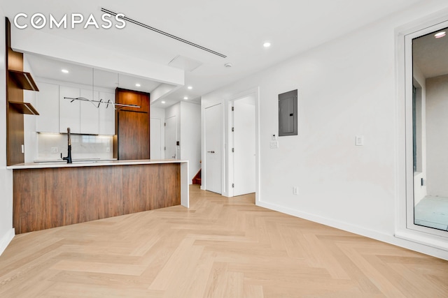 90 Herbert St Ph, Ph, New York City, NY 11222 - kitchen with electric panel, modern cabinets, light countertops, a peninsula, and white cabinets