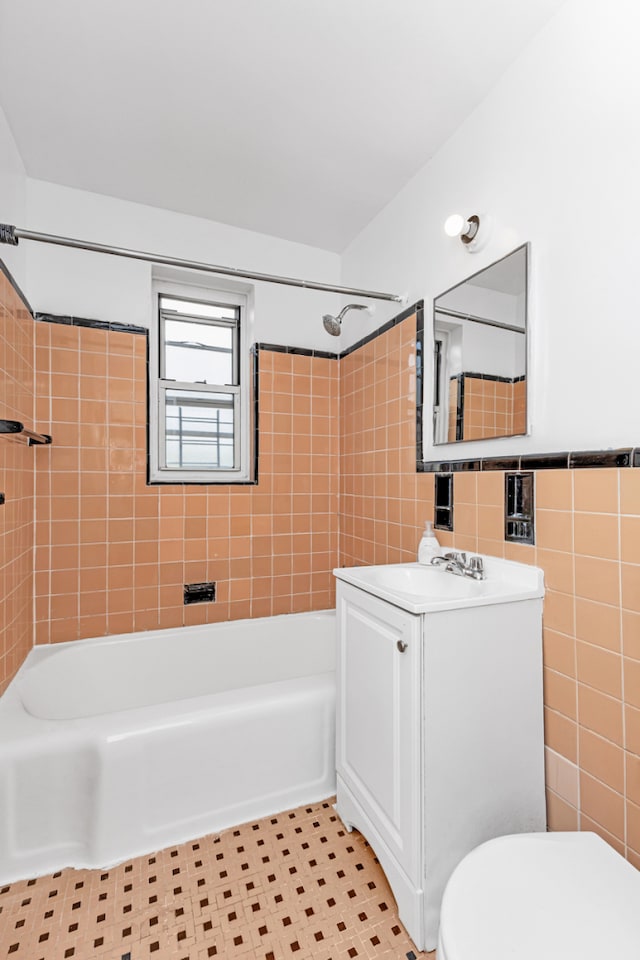105-34 65th Ave Unit 4G, New York City, NY 11375 - bathroom featuring tile walls, vanity, toilet, and bathing tub / shower combination