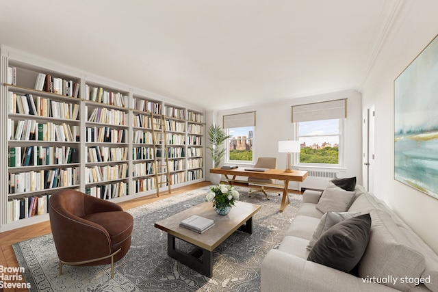 956 5th Ave Unit 11Thfloor, New York City, NY 10075 - living area with radiator, ornamental molding, and wall of books