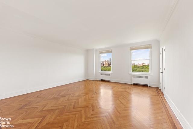 956 5th Ave Unit 11Thfloor, New York City, NY 10075 - unfurnished room featuring radiator heating unit, crown molding, and baseboards