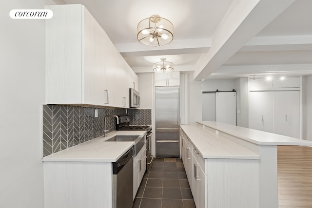 155 E 49th St Unit 5A, New York City, NY 10017 - kitchen featuring stainless steel appliances, decorative backsplash, light countertops, a chandelier, and beamed ceiling