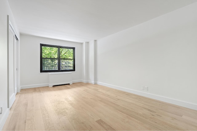 142 W End Ave Unit 2U, New York City, NY 10023 - unfurnished bedroom featuring light wood finished floors, baseboards, and a closet