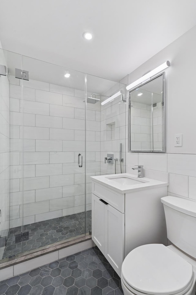 142 W End Ave Unit 2U, New York City, NY 10023 - bathroom featuring vanity, toilet, tile patterned floors, a shower stall, and recessed lighting