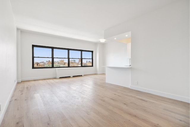 180 W End Ave Unit 30R, New York City, NY 10023 - unfurnished room with light wood-style flooring, recessed lighting, and radiator
