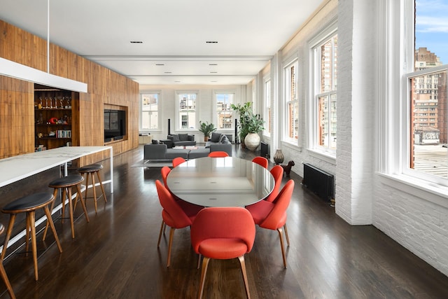 43 W 13th St Unit 7R, New York City, NY 10011 - dining area with a fireplace, radiator heating unit, dark wood-style flooring, and healthy amount of natural light