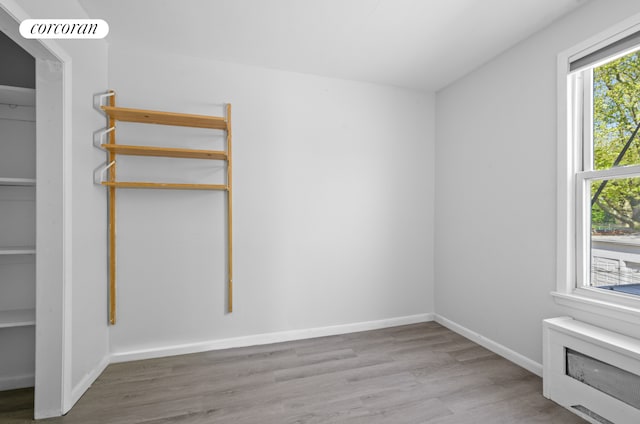 21 E 4th St, New York City, NY 11218 - spare room with wood finished floors and baseboards