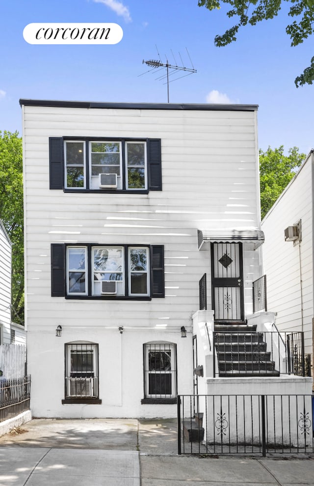 21 E 4th St, New York City, NY 11218 - view of front of home with a fenced front yard