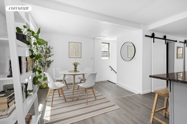 21 E 4th St, New York City, NY 11218 - dining area with a barn door and wood finished floors