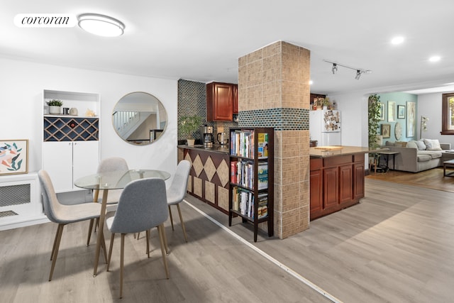 21 E 4th St, New York City, NY 11218 - dining space with light wood-type flooring and rail lighting