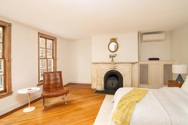69 Orange St Unit 1, New York City, NY 11201 - bedroom featuring a wall mounted air conditioner, wood finished floors, and multiple windows