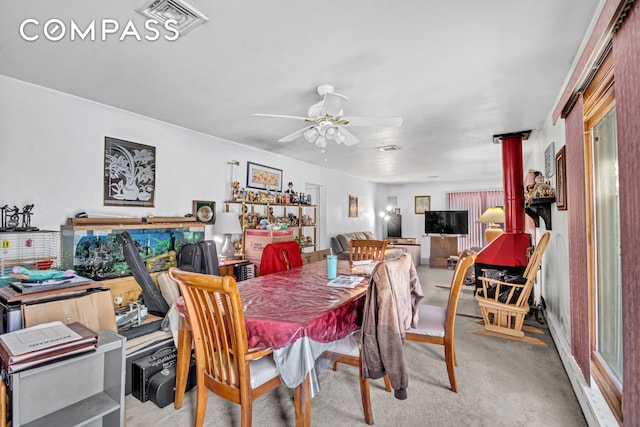 2 Livingston Ct, New York City, NY 10310 - dining room with carpet floors, ceiling fan, and a wood stove