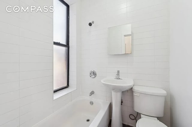 66 W 138th St Unit 1A, New York City, NY 10037 - bathroom with toilet, shower / bathtub combination, tile walls, and a sink