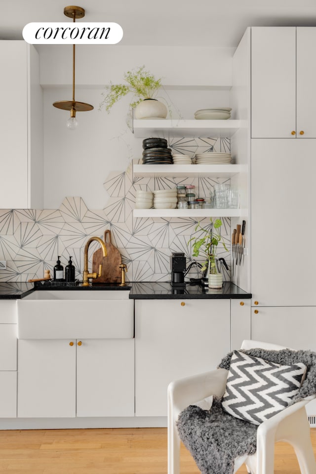 170 2nd Ave Unit 9B, New York City, NY 10003 - kitchen featuring white cabinets, decorative backsplash, and dark countertops