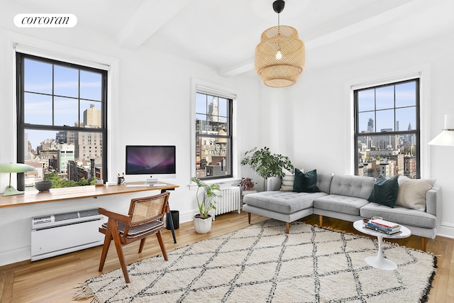 170 2nd Ave Unit 9B, New York City, NY 10003 - living room with radiator, healthy amount of natural light, beamed ceiling, and wood finished floors