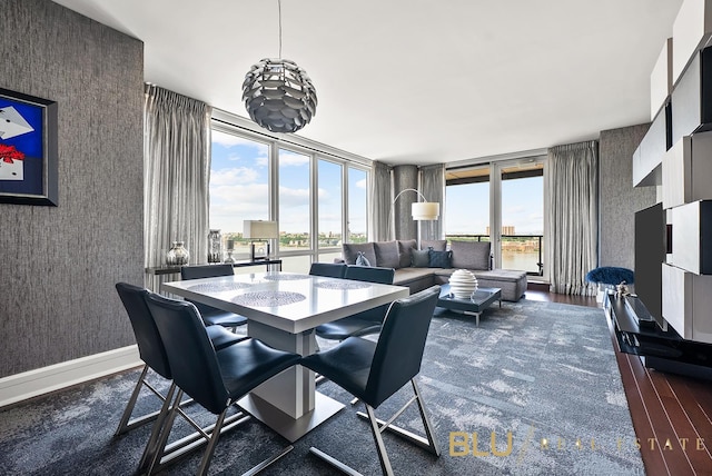60 Riverside Blvd Unit 2403, New York City, NY 10069 - dining space with dark wood finished floors, wallpapered walls, and expansive windows