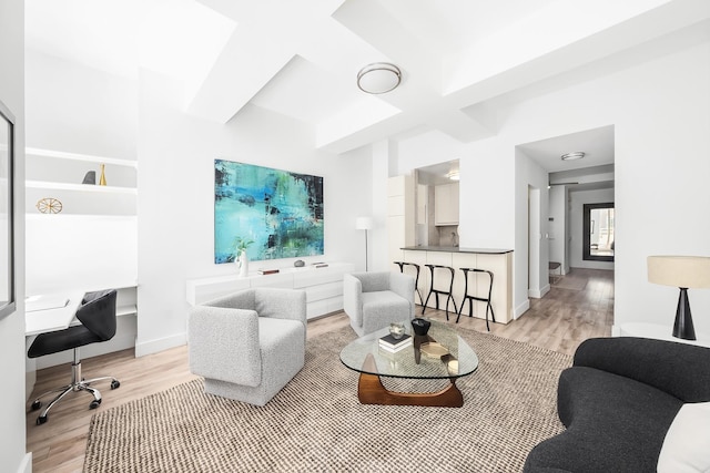 99 John St Unit 1112, New York City, NY 10038 - living area with light wood-style floors, beamed ceiling, baseboards, and a desk