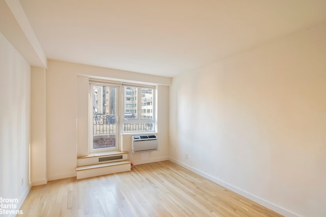 30 E 62nd St Unit 11A, New York City, NY 10065 - empty room with wood finished floors, an AC wall unit, and baseboards