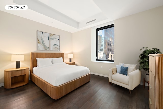 20 W 53rd St Unit 18A, New York City, NY 10103 - bedroom featuring dark wood finished floors, a tray ceiling, and baseboards