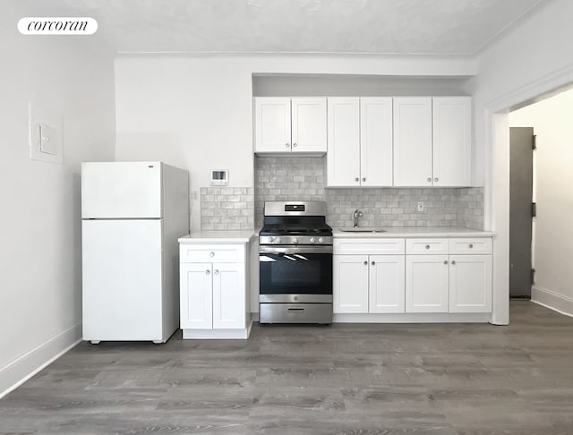 24-75 38th St Unit C9, New York City, NY 11103 - kitchen featuring stainless steel range with gas stovetop, freestanding refrigerator, light countertops, white cabinets, and backsplash