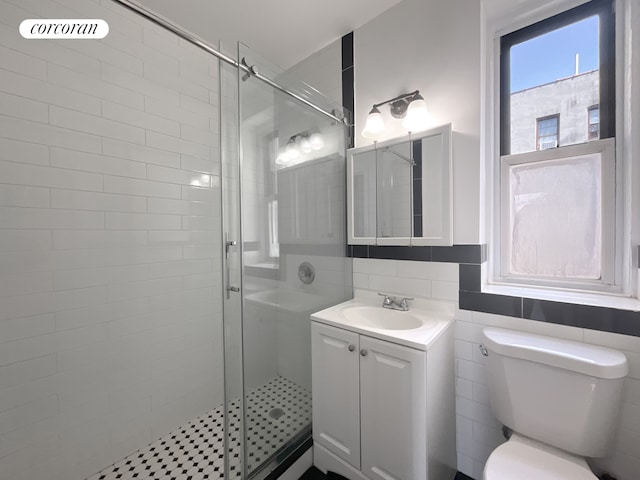 24-75 38th St Unit C9, New York City, NY 11103 - bathroom featuring a stall shower, vanity, and tile walls