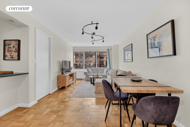 60 W 13th St Unit 8B, New York City, NY 10011 - dining room featuring baseboards and rail lighting