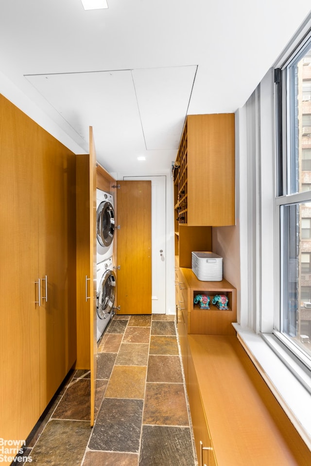 54 Riverside Dr Unit 9D, New York City, NY 10024 - washroom with stacked washer and clothes dryer and stone tile floors