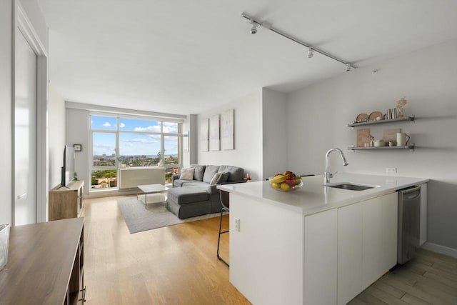 189 Schermerhorn St Unit 16C, New York City, NY 11201 - kitchen with a sink, light wood finished floors, white cabinetry, light countertops, and modern cabinets